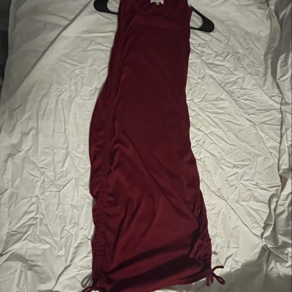 Red sleeveless dress. Knee length. Ties on side for scrunch option
